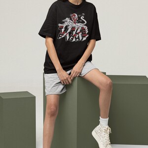 Studio lifestyle shot of a white long-sleeve tee on a model, featuring title fight on the chest area.