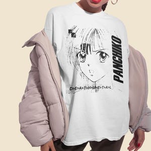 White unisex t-shirt worn by a model, front print display showing panchiko deathmetal album clearly.