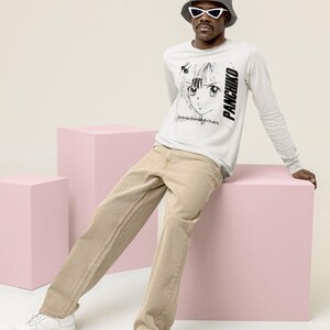 White long-sleeve t-shirt lifestyle scene with soft lighting, featuring panchiko deathmetal album on the front.