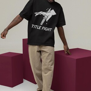 White short-sleeve t-shirt lifestyle photo outside, featuring title fight on the chest.