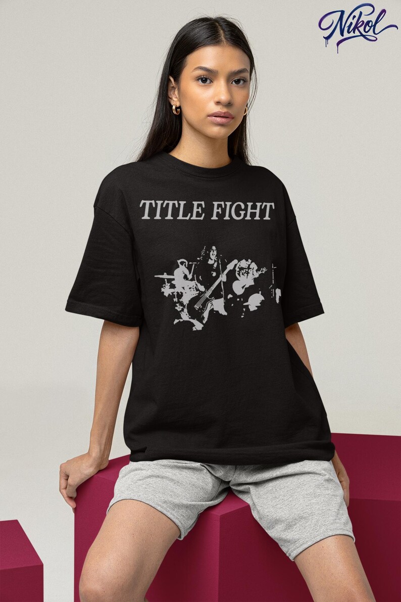 E-commerce lifestyle mockup of a white sweatshirt on a model, front print shown as Title Fight.