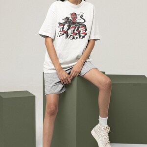 Casual outfit photo with a white crewneck t-shirt, front print shown as title fight.