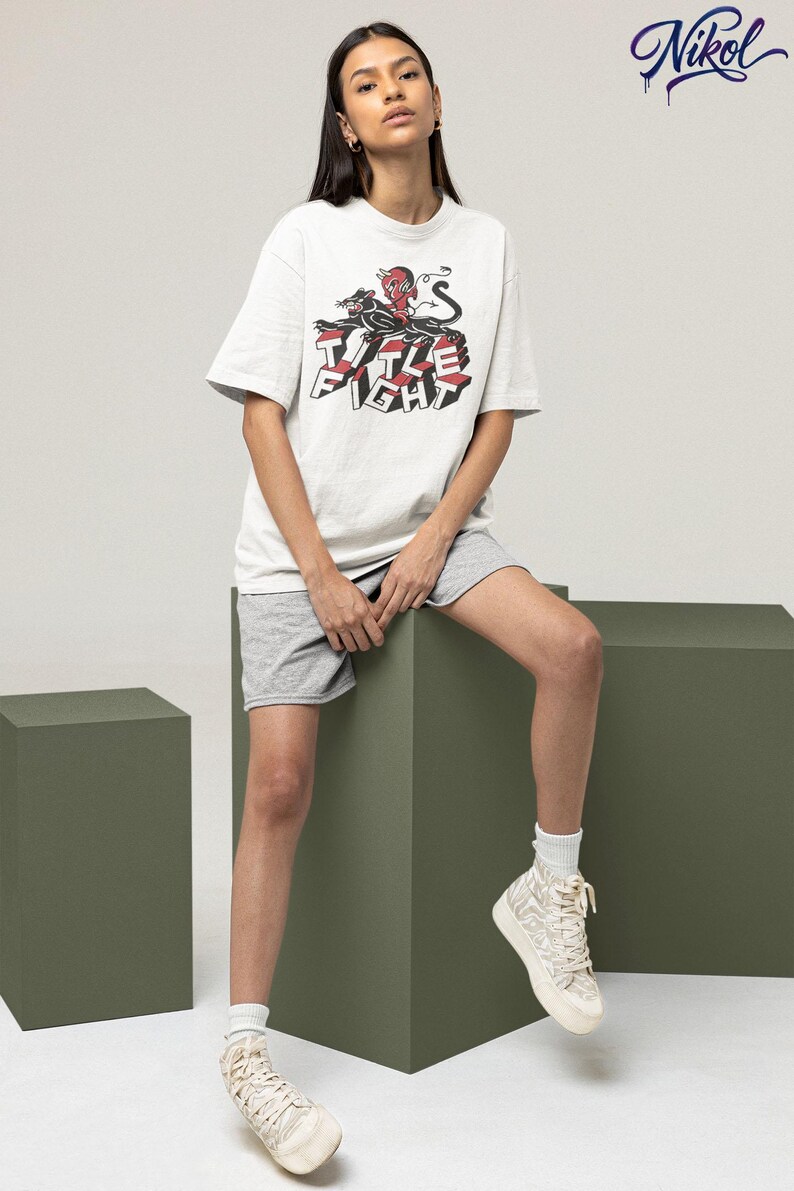 Casual outfit photo with a white crewneck t-shirt, front print shown as title fight.