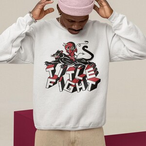White crewneck sweatshirt lifestyle mockup, front design area showing title fight clearly.