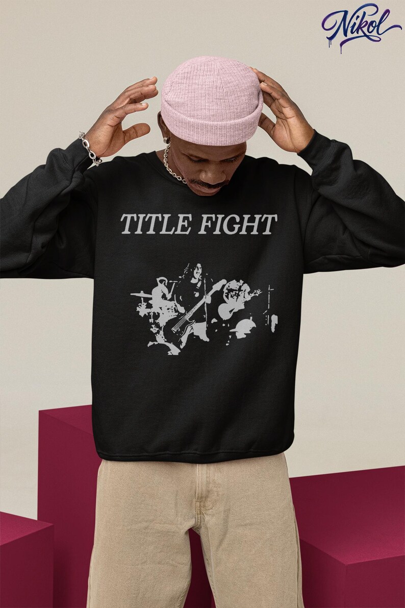 Back-facing hoodie lifestyle image, white hoodie with Title Fight displayed on the back print area.