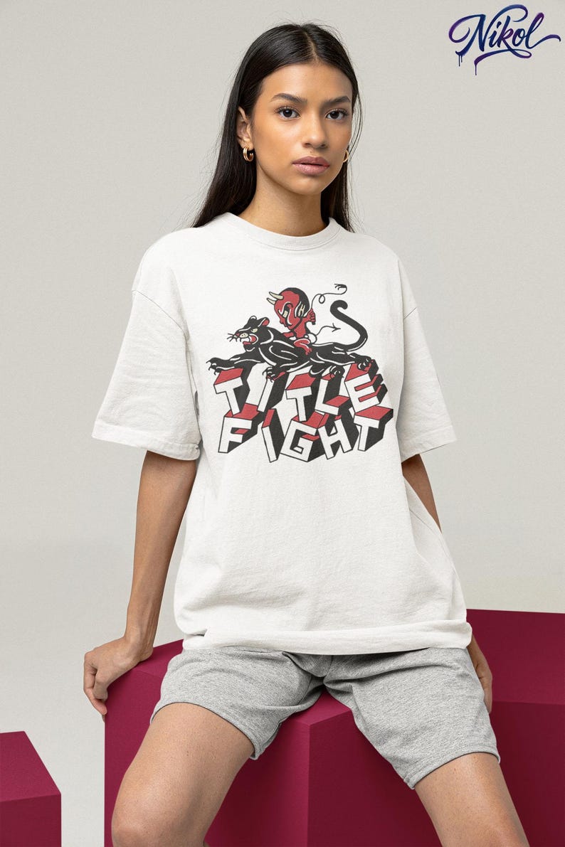 E-commerce lifestyle mockup of a white oversized tee on a model, front print shown as Title Fight.