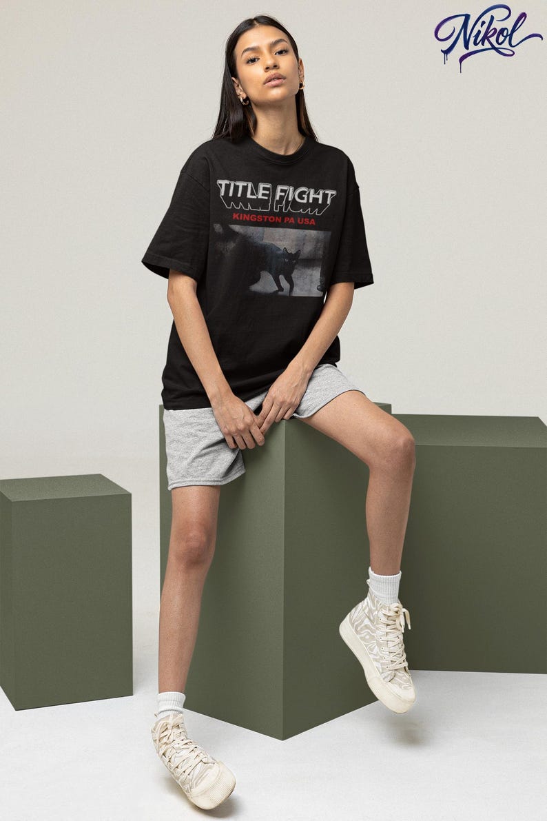 Model wearing a white long-sleeve t-shirt, front print placement featuring Title Fight.