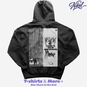 May include: Black hoodie with a graphic design on the back. The design features the text "I WANT TO DIE IN NEW ORLEANS" and "IS THIS OUR GRAVE?" in a stylized font. The hoodie also features the brand name "Nikol" in a cursive font.