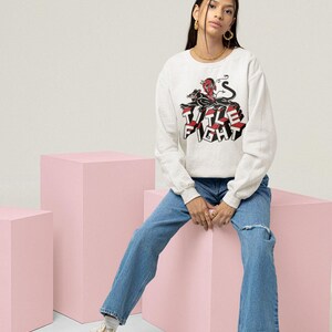 White long-sleeve t-shirt worn by a model, front print display showing Title Fight clearly.