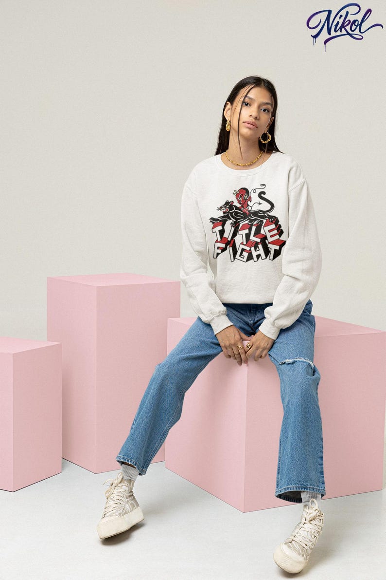 White long-sleeve t-shirt worn by a model, front print display showing Title Fight clearly.