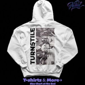 May include: A light grey hoodie with a black and white graphic on the back. The graphic features a collage of images and the word "TURNSTILE" printed vertically on the left side. The text "T-shirts & More" is at the bottom.