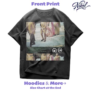 May include: Charcoal grey t-shirt with a retro graphic print. The print shows a faded image of people, text, and two circular portraits. The word "Nikol" is written in a stylized script.
