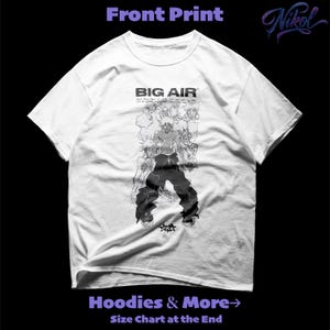 May include: White t-shirt with a black and white graphic print. The front print features the text "BIG AIR" above a detailed illustration of a person and other figures. The shirt also has the text "Hoodies & More" and "Size Chart at the End".