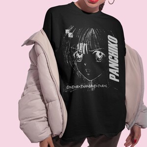 Lifestyle photo of a model wearing an oversized white t-shirt with Panchiko deathmetal album printed on the front.