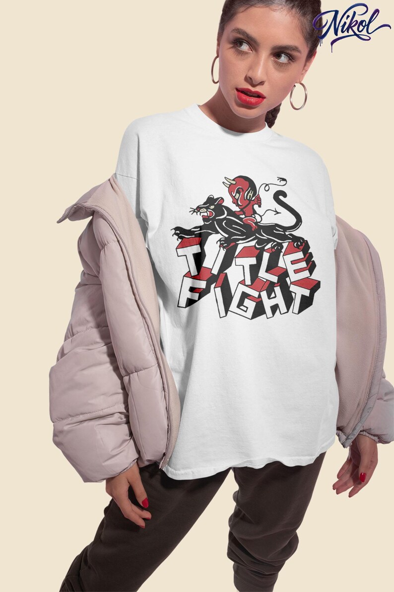 Lifestyle photo of a model wearing a white t-shirt with title fight printed on the front.