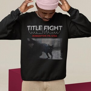 White hoodie back print lifestyle mockup with hood up, showcasing Title Fight on the back panel.