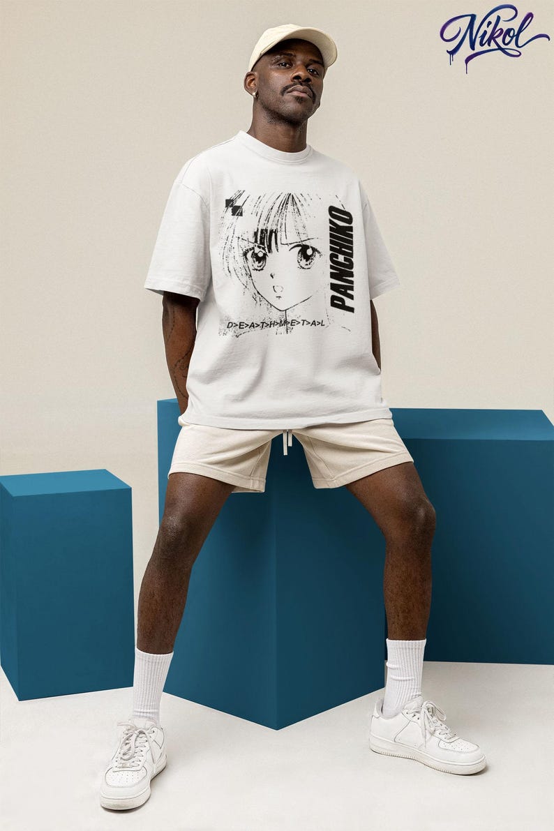 Model wearing a white unisex t-shirt with panchiko deathmetal album printed on the front, neutral studio background.