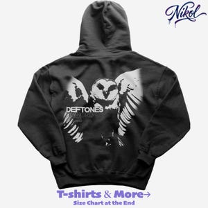 May include: Black hoodie featuring a white graphic of an owl with outstretched wings. The text "DEFTONES DIAMOND EYES" is above the owl. The bottom of the hoodie has the text "T-shirts & More -> Size Chart at the End".