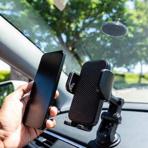 May include: A white ceramic mug with a black handle and the text "But First, Coffee" in a bold, black font. The mug sits on a white surface, showcasing its clean design.
