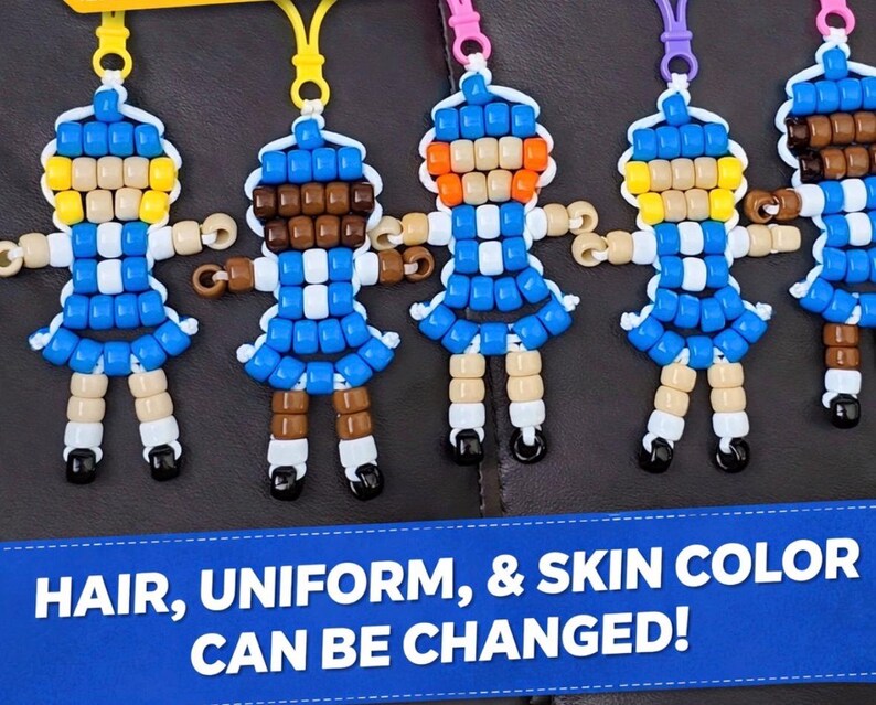 May include: A collection of five small doll-shaped keychains crafted from colorful plastic pony beads, each featuring a blue dress, white accents, and a plastic clip. A blue banner at the bottom displays the text: HAIR, UNIFORM, & SKIN COLOR CAN BE CHANGED!