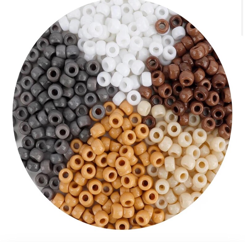 May include: A collection of small, cylindrical pony beads arranged in a circular display. The beads are sorted into five distinct color groups: solid white, dark charcoal gray, rich chocolate brown, light tan, and creamy off-white.