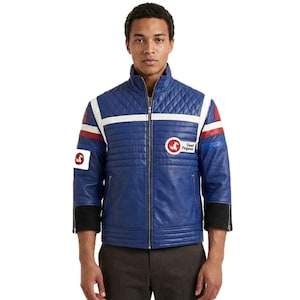 May include: A blue leather jacket with a quilted design on the shoulders and upper chest. The jacket features white stripes, red accents, and a "Dead Pegasus" logo patch. It has a zip-up front and black cuffs.