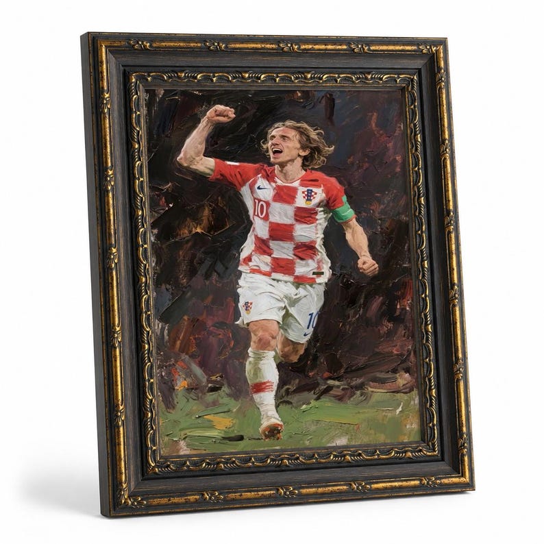 May include: Framed oil painting of a soccer player in a red and white checkered jersey, number 10, celebrating a goal. The painting is in a dark, ornate frame with gold accents.