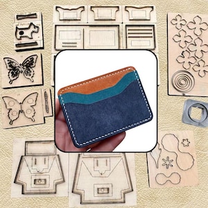 May include: A rectangular leather card holder featuring three horizontal layers in rust orange, teal, and dark navy blue, stitched together with white thread. The card holder is displayed against a background of various wooden cutting dies.