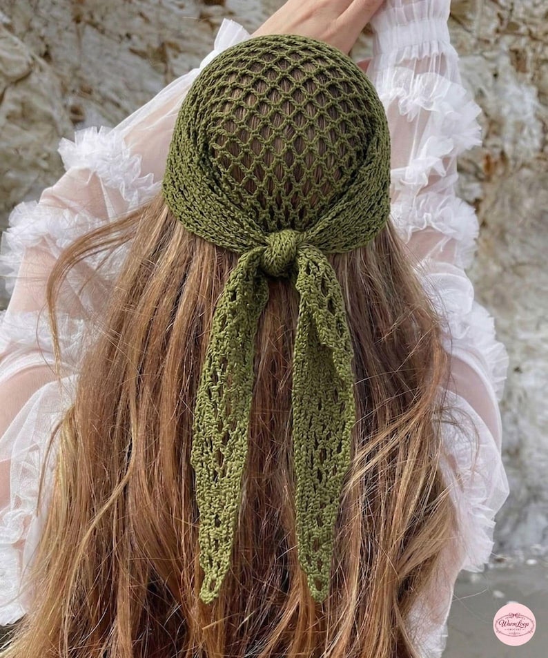 May include: Olive green crochet head covering with a net-like design. The head covering is tied at the nape of the neck with long, openwork ties. The head covering is shown on a person with long, light brown hair.