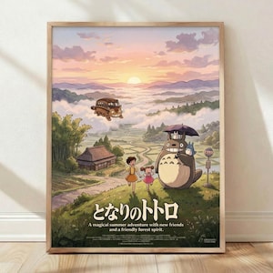 May include: Framed poster print displayed against white wall on wooden floor. Artwork shows beloved forest spirit Totoro with umbrella standing beside two children at rural bus stop, with flying catbus overhead. Mountain landscape background features sunset sky in pink and orange hues with rolling hills and traditional Japanese house. Natural wood frame, soft natural lighting with gentle shadows.