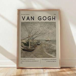 May include: Framed print of Van Gogh's "Fishing Boats on the Beach at Saintes-Maries." The artwork features several boats on a beach with a sailboat in the distance. The print includes the text "Van Gogh Museum" and "1888."