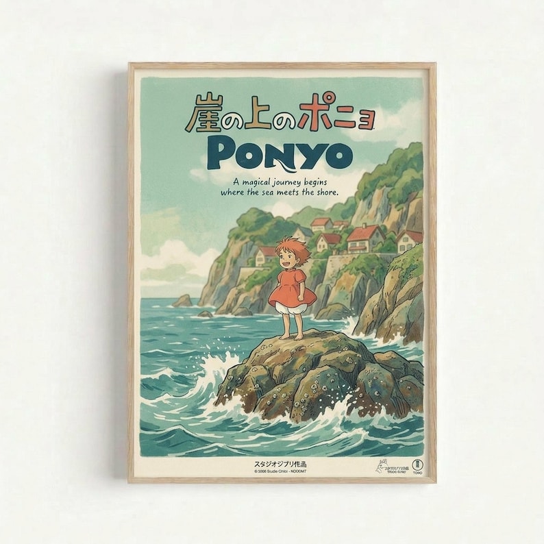 A framed vintage-style poster featuring Ponyo anime artwork with Japanese text at the top and "PONYO" in large blue letters. The illustration shows a young girl in a red dress standing on rocky cliffs above churning ocean waves, with a coastal village nestled in green hills behind her. The artwork has soft, muted colors in blues and greens with a dreamy, hand-painted aesthetic. The poster is displayed in a light wood frame against a white wall.