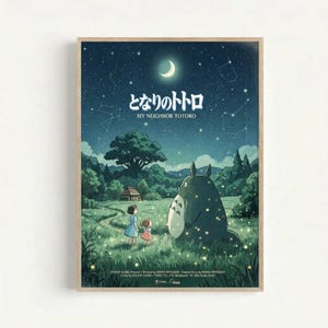 Framed poster featuring Totoro and two children in a moonlit meadow scene. The artwork shows a large gray forest spirit sitting beside two young girls against a starry night sky with crescent moon and constellation patterns. Rolling green hills, trees, and a small house create the pastoral landscape background. The image has a dreamy, animated film aesthetic with soft blues and greens. Japanese text appears at the top with English translation below. Studio credits are visible at the bottom of th