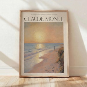 May include: Framed art print featuring a coastal landscape painting by Claude Monet. The artwork depicts a beach scene with a figure, ocean waves, and a sunset. The frame is a light wood color, and the text "CLAUDE MONET" is at the top.