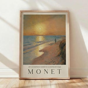 May include: Framed art print of a beach scene at sunset, featuring a person walking on the sand. The artwork has a warm color palette with shades of orange, yellow, and blue. The text "MONET" is displayed at the bottom.