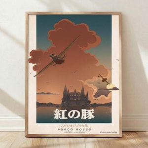 May include: A framed poster featuring a Porco Rosso illustration with two airplanes flying over a castle and water at sunset. The artwork includes large orange clouds, a dark blue sky, and the Japanese text 紅の豚 with English text Porco Rosso.