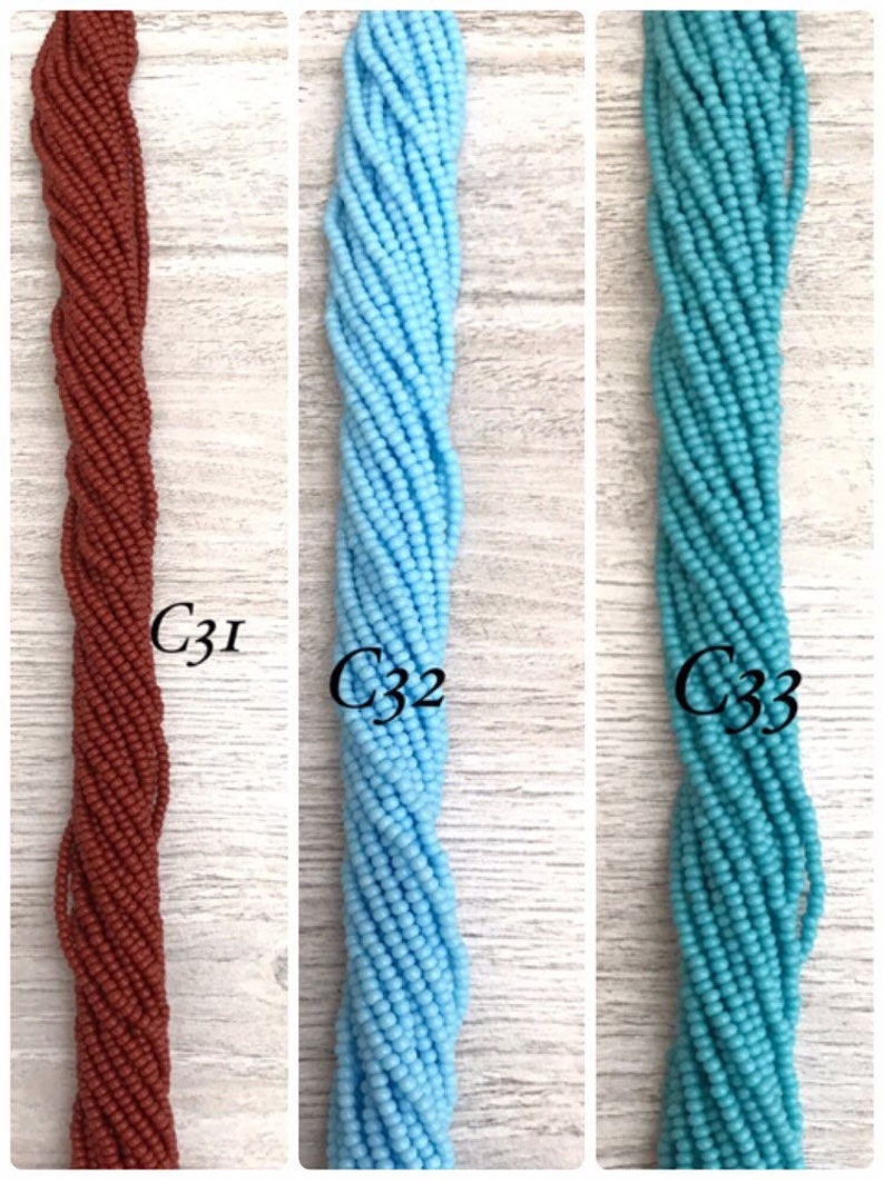 May include: Three strands of seed beads, one brown, one light blue, and one turquoise.