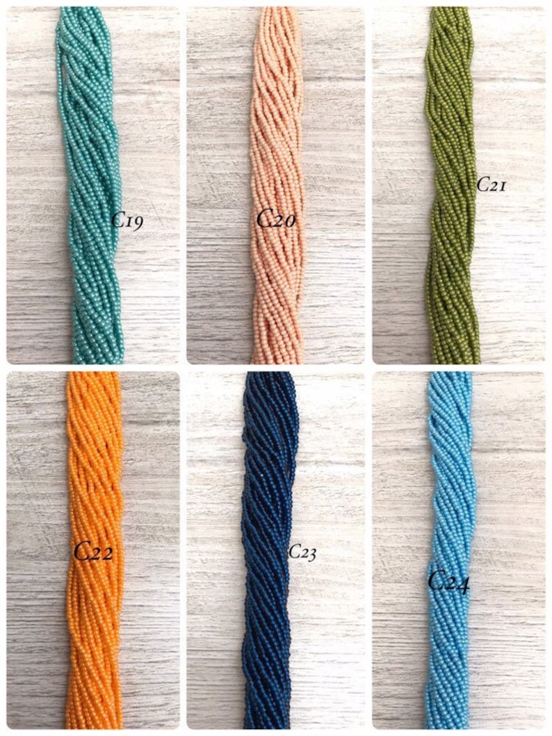 May include: Six strands of seed beads in different colours, labelled C19 through C24. The colours are teal, peach, olive green, orange, navy blue, and light blue.