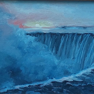 May include: An oil painting of a waterfall scene, framed in a decorative, ornate frame. The artwork depicts a cascading waterfall with shades of blue and white, with a hint of pink and orange in the sky. The frame has a distressed, textured appearance.