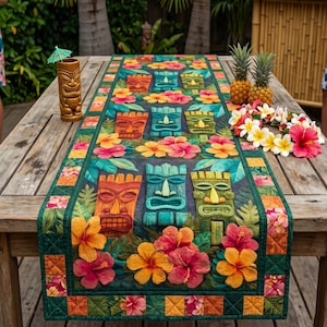 May include: A vibrant table runner with a tropical design. It showcases tiki masks in orange, blue, and green, set amongst hibiscus flowers. The runner is on a wooden table, with a tiki mug and pineapples nearby.
