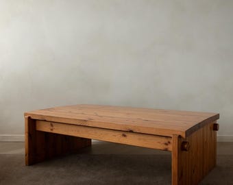 May include: A rectangular wooden coffee table with a natural finish. The table has a low profile with thick legs and a solid top. The dimensions are approximately 60 inches long, 30 inches wide, and 15 inches high.