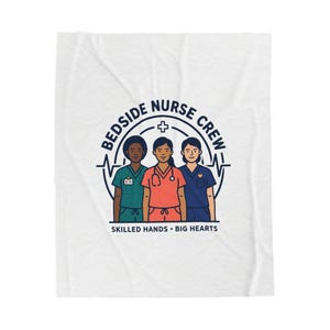 May include: White blanket featuring a graphic of three nurses in teal, coral, and navy scrubs. The design includes the text "BEDSIDE NURSE CREW" in a circular arrangement, with a cross symbol and a heartbeat line. Below, it reads "SKILLED HANDS • BIG HEARTS."