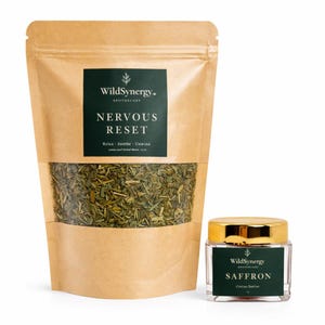 May include: A brown paper bag with a clear window displaying green herbs, labeled "Nervous Reset." Beside it, a small glass jar with a gold lid and a label reading "Saffron." The products are from WildSynergy Apothecary.