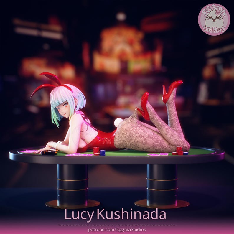 May include: A figurine of a character with short light blue hair wearing red bunny ears, a red leotard, and patterned tights with red high heels. The character is lying on a green poker table with chips and cards. The text Lucy Kushinada is visible.