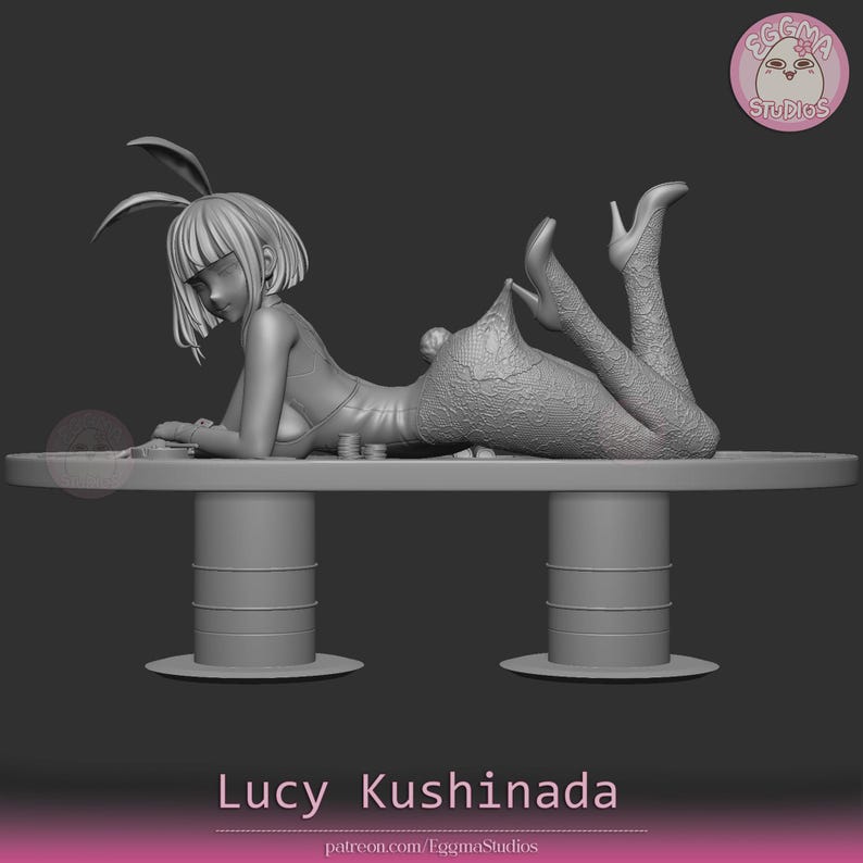 May include: A gray 3D model of a character with short hair and bunny ears, wearing a leotard and textured tights, lying prone on a long table. The figure is positioned with legs raised, and the text Lucy Kushinada is displayed at the bottom.