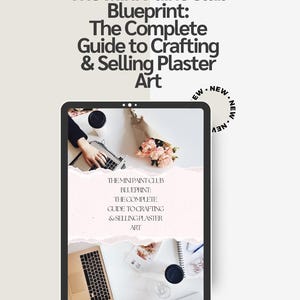 May include: A digital tablet displaying a guide titled The Mini Paint Club Blueprint: The Complete Guide to Crafting & Selling Plaster Art. The screen shows a top-down view of a desk with a laptop, a bouquet of pink flowers, and stationery.