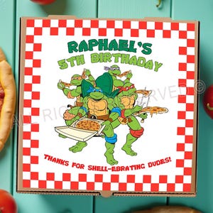 May include: A square pizza box with a red and white checkered border. The box features a cartoon image of the Teenage Mutant Ninja Turtles and the text "RAPHAEL'S 5TH BIRTHDAY". The text "THANKS FOR SHELL-EBRATING DUDES!" is also included.