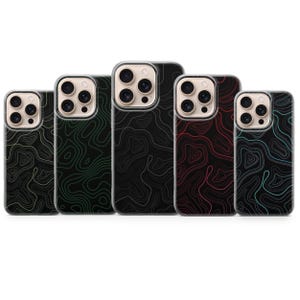 May include: A collection of five phone cases with a topographic map design. The cases feature a black background with contour lines in green, red, and teal. The cases have a clear border and a camera cutout.