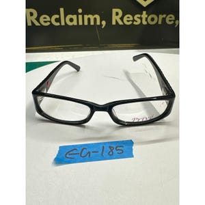 May include: Black rectangular eyeglasses with the word "Privé" printed on the lens. The glasses have a sleek, modern design with a glossy finish. The arms of the glasses are slightly curved for a comfortable fit. The text "Reclaim, Restore" is visible in the background.