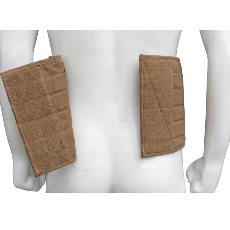 May include: Tan-colored padded tactical vest components. The rectangular pads have a quilted design and are attached with Velcro. The pads are designed to be worn on the back and sides of the torso.